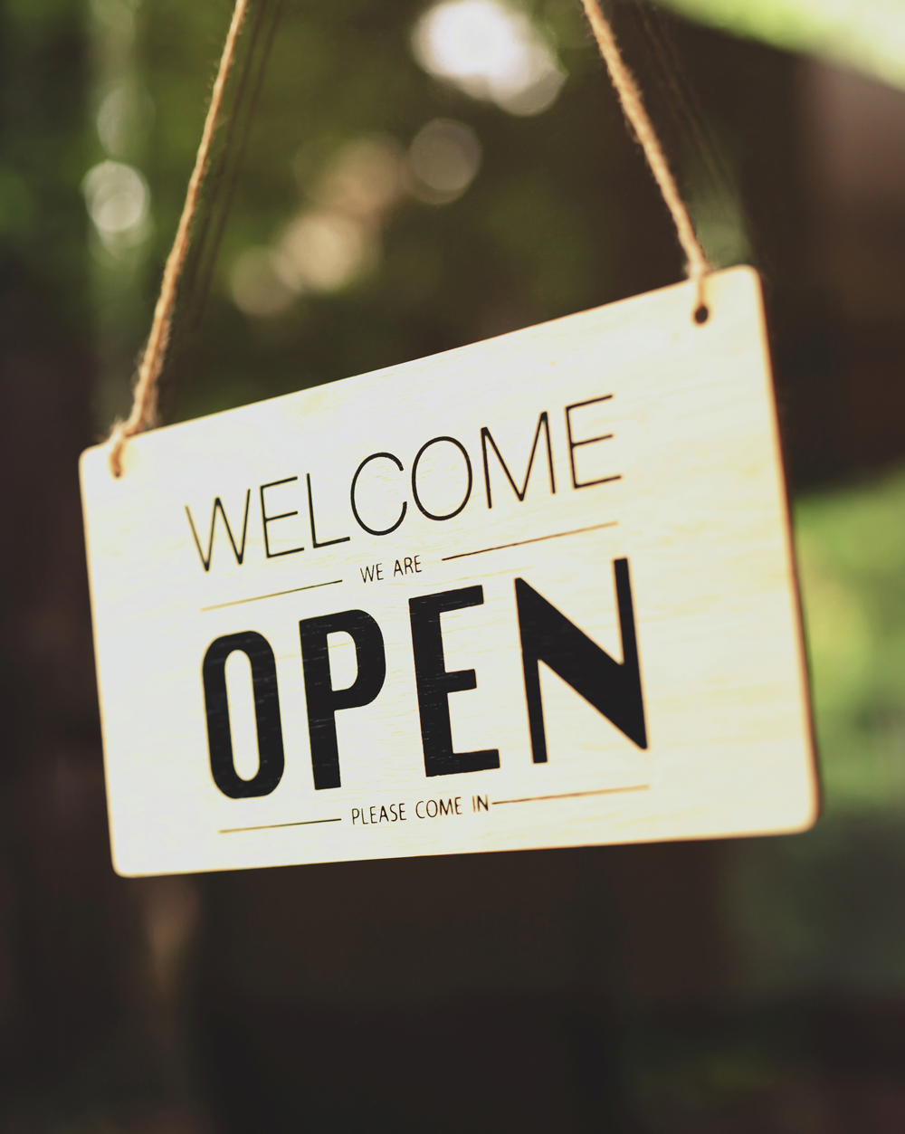 open sign hanging in a window