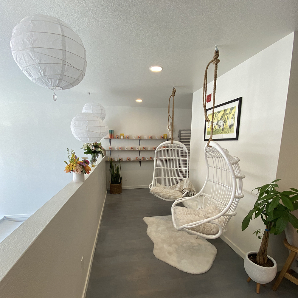 The Heavenly Upstairs floor of Refuge Acupuncture's office, in which there are hanging chairs and lanterns hung from the ceiling