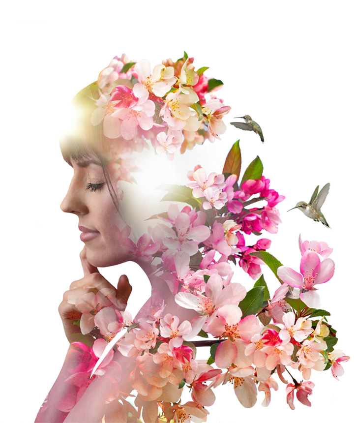 The side profile of a woman with her face propped up on her finger, on which an image of flowers and hummingbirds has been overlaid.