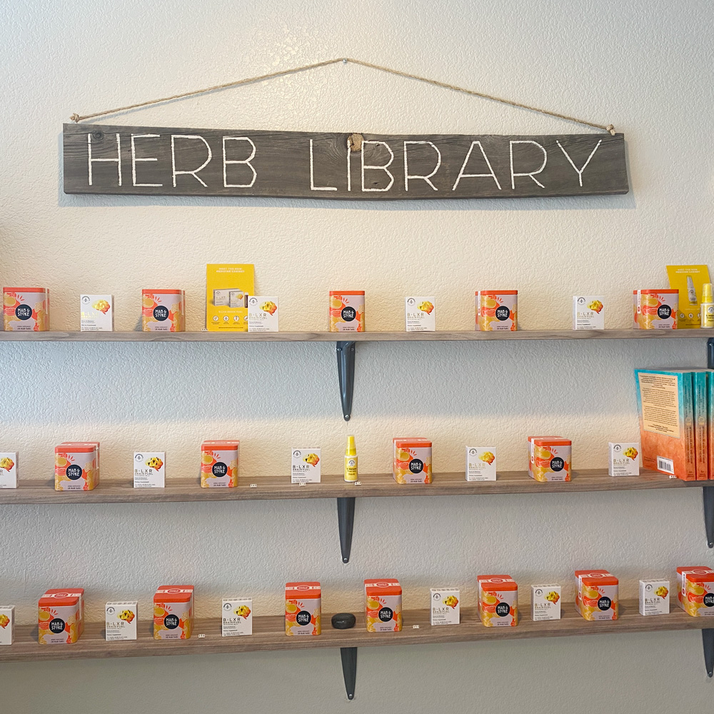 The Refuge Herb Library in which rows of orange containers are lined on shelves.